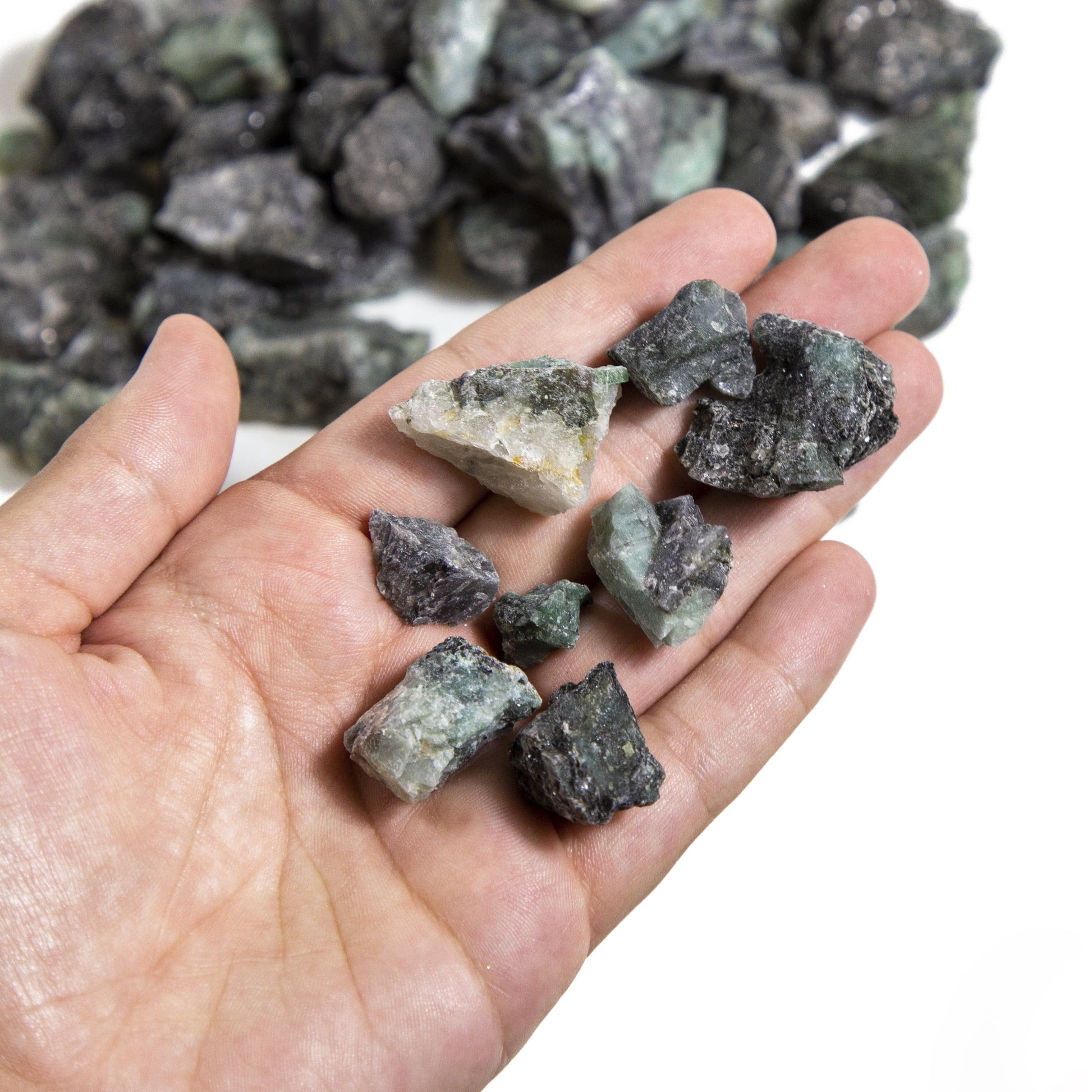 Small pieces of a Emerald Rough Stone in hand.