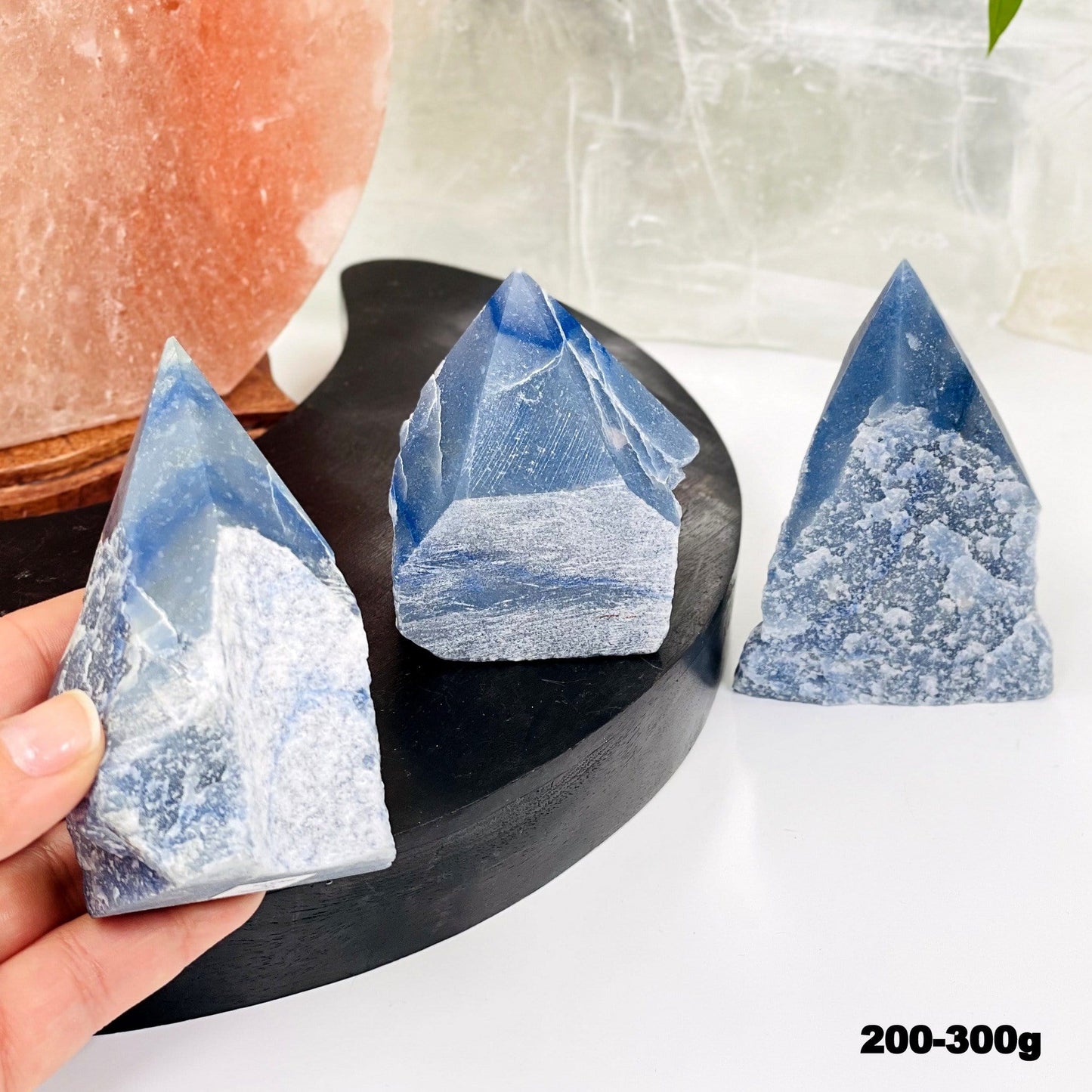 blue quartz point in hand for size reference 