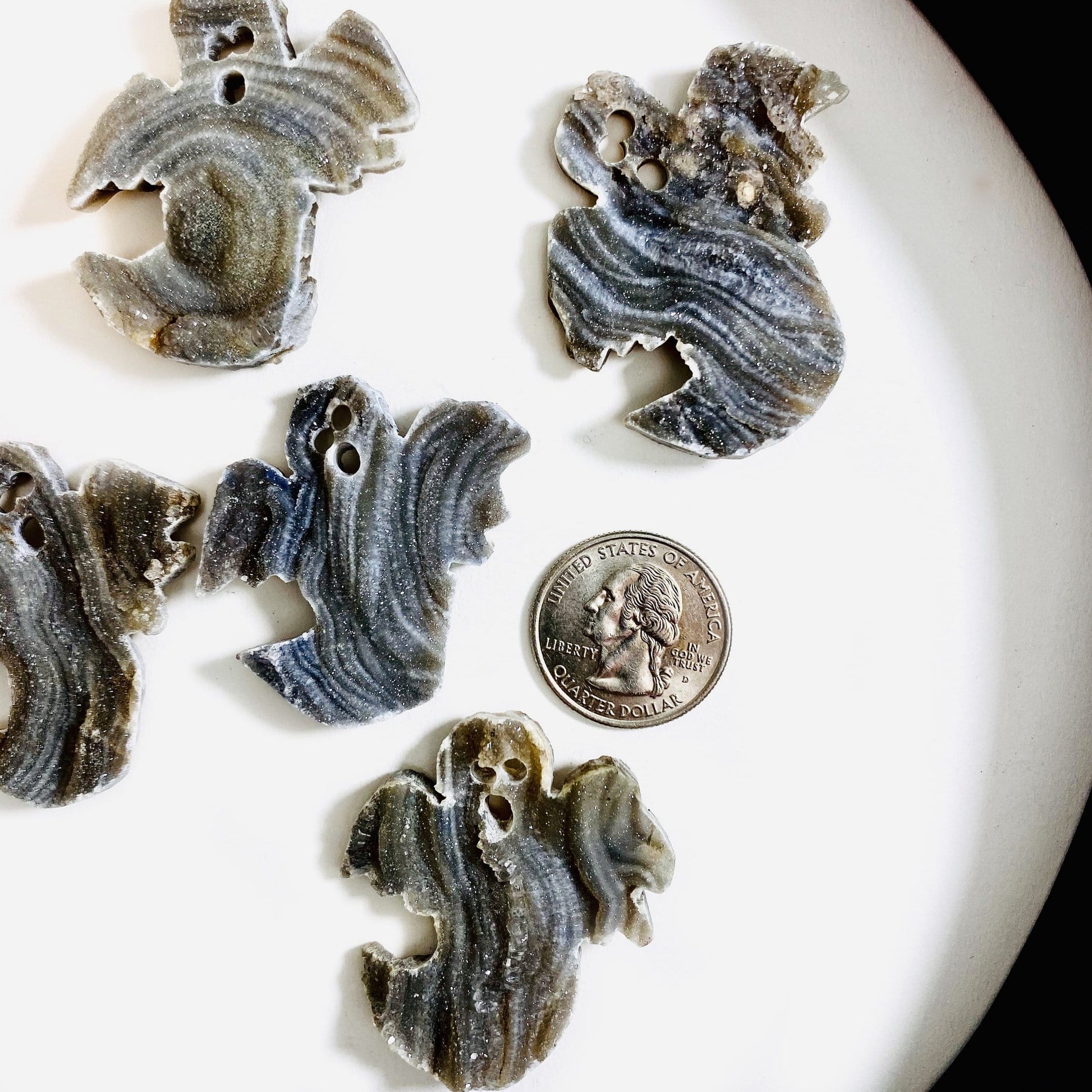 Style 2 Chalcedony Ghost Cabochons next to a quarter for size reference