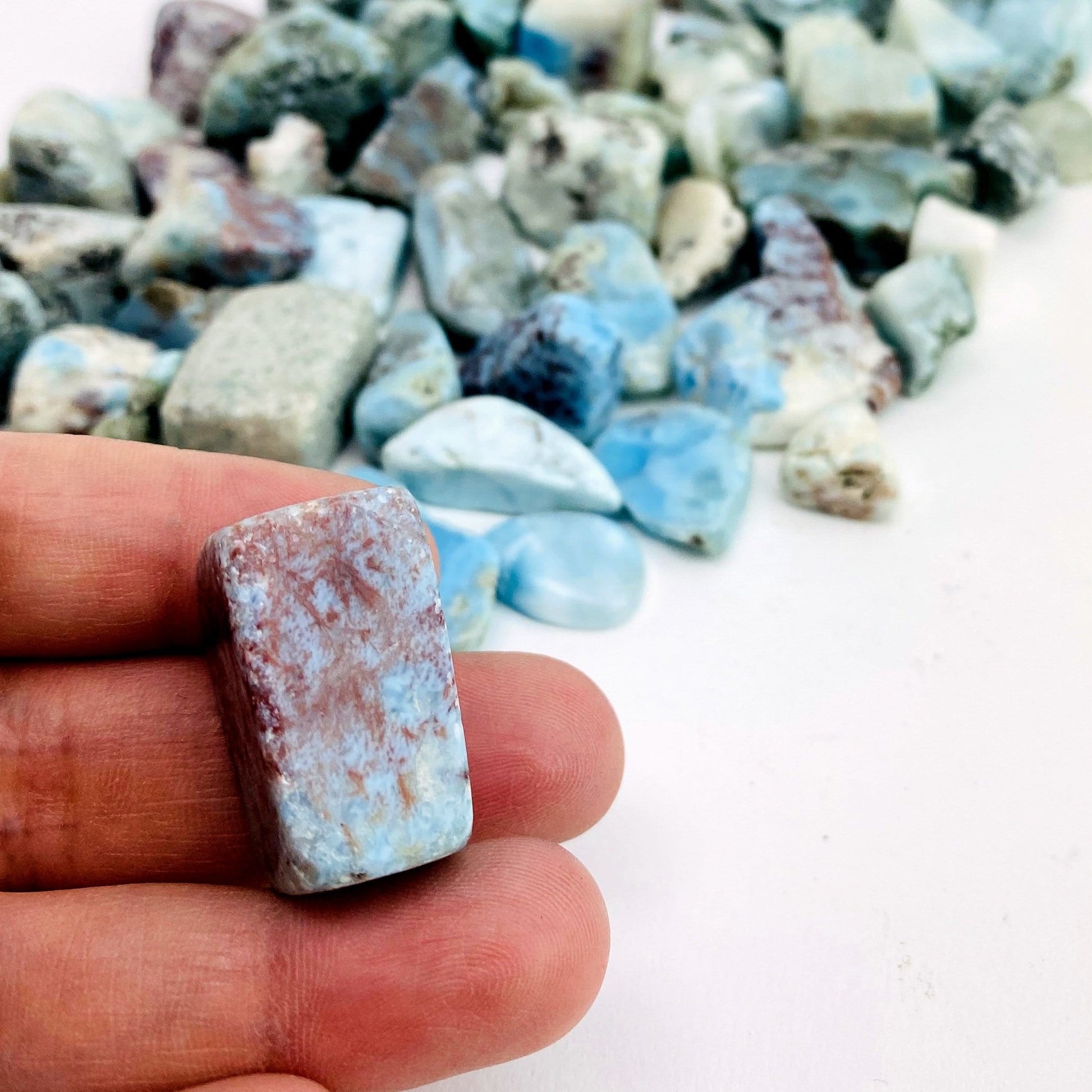 tumbled stone in hand for size reference