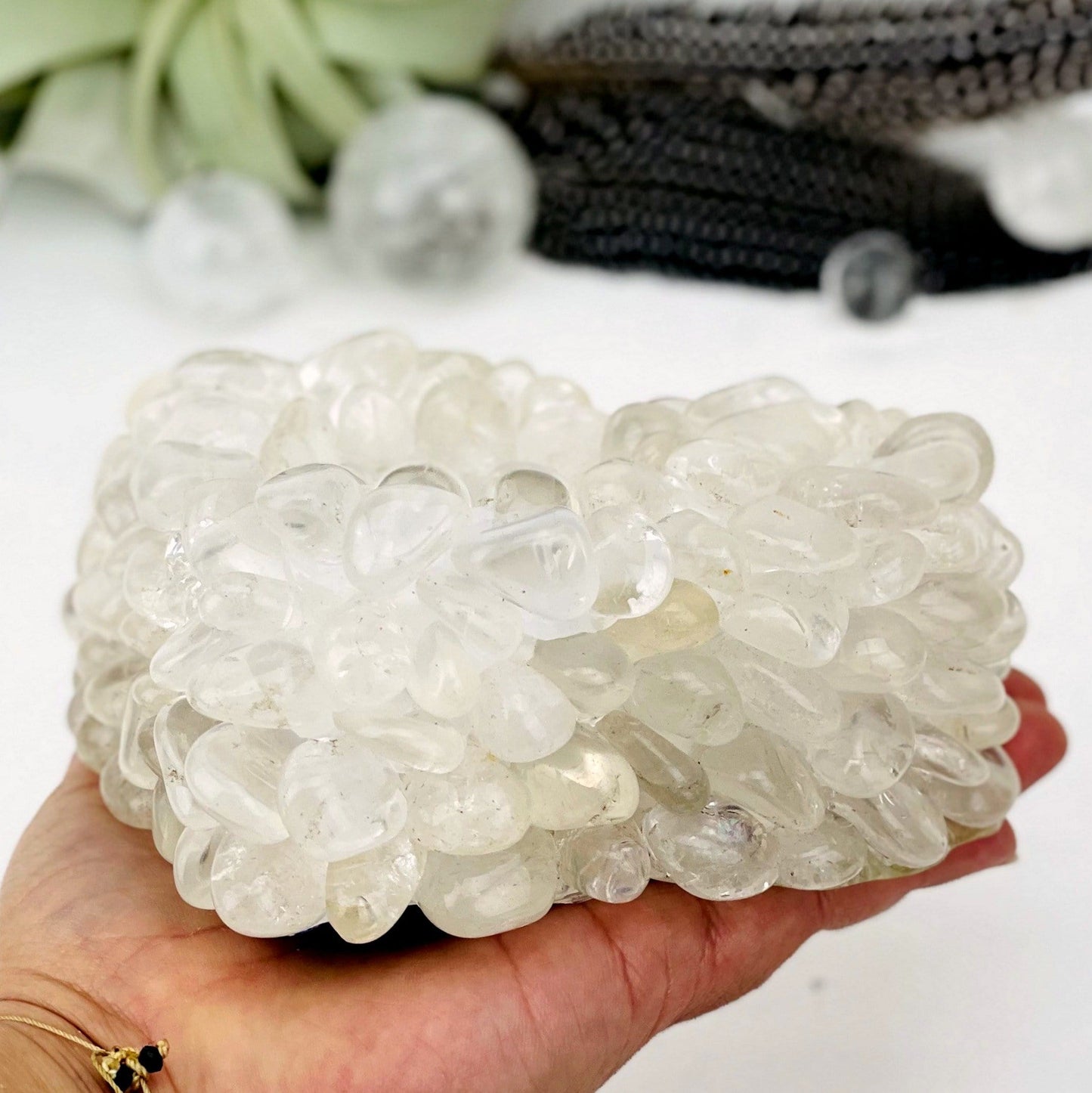 Heart shaped candle holder that is made with crystal quartz tumbled stones that are glued together.