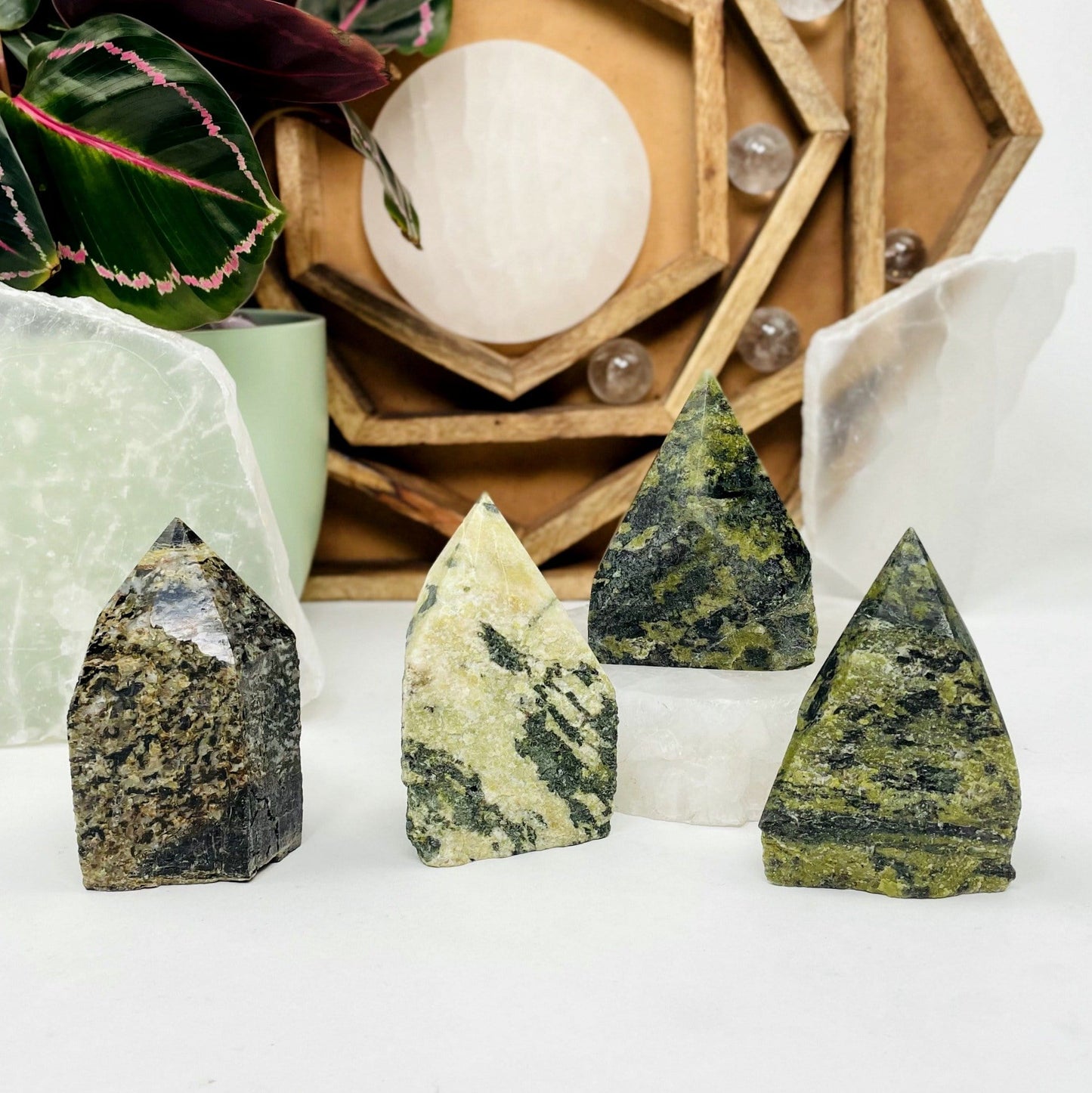 4 Jadeite Semi-polished Points displayed on a white surface.