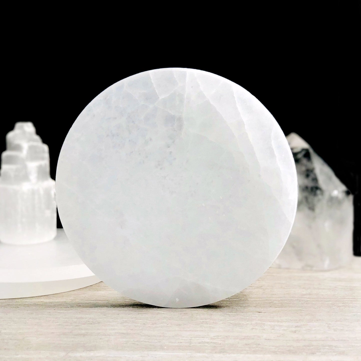 15cm round selenite charging plate propped up for details