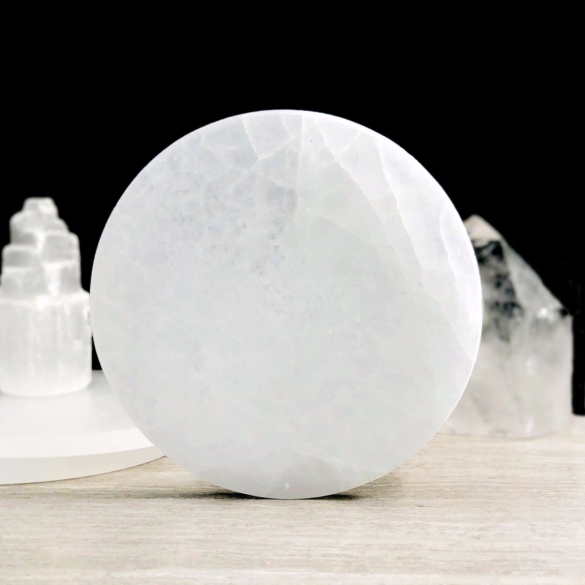 15cm round selenite charging plate propped up for details