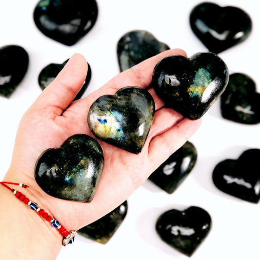labradorite hearts in hand for size reference 