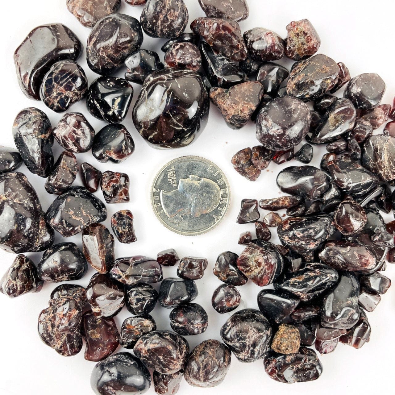 Garnet Small Tumbled Stones around a quarter for size reference
