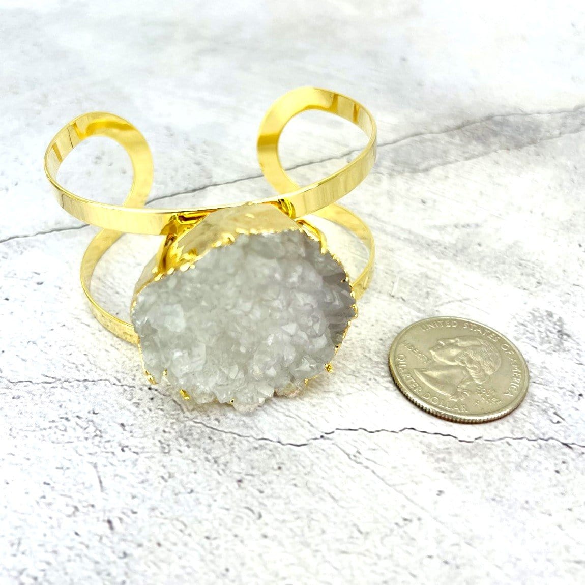 bracelet next to a quarter
