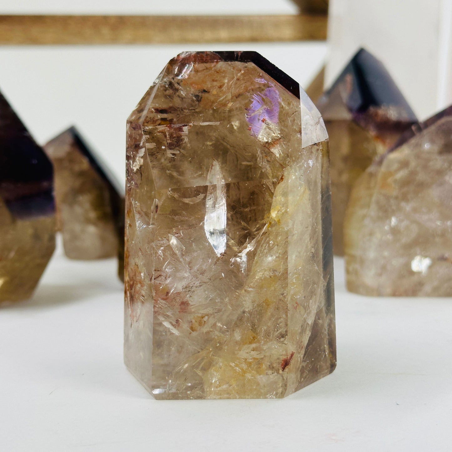 ametrine polished points with decorations in the background