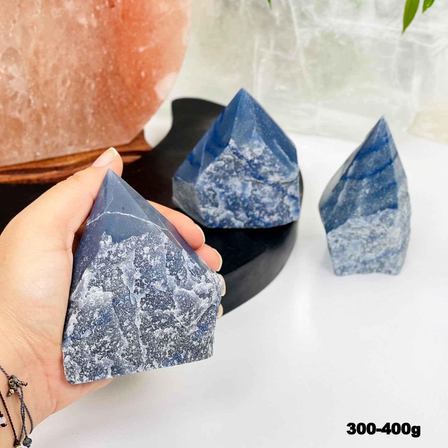blue quartz point in hand for size reference 
