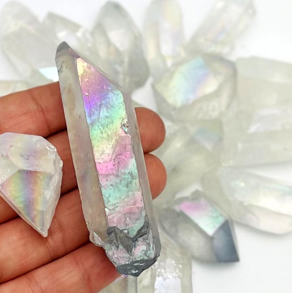 crystal quartz points coated in angel aura showing the different colors and size variations