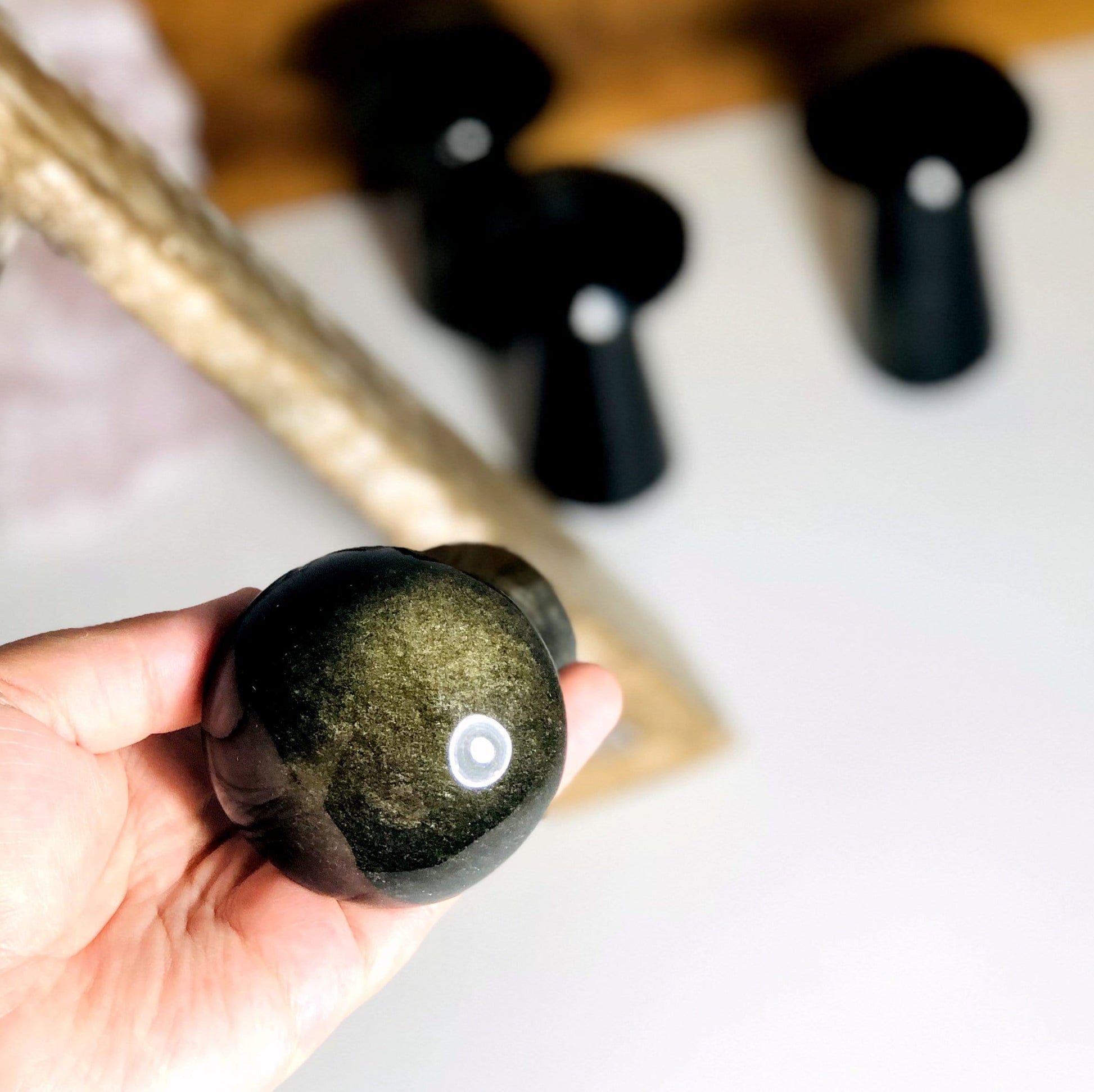 Gold Sheen Obsidian Polished Mushroom in hand for size reference