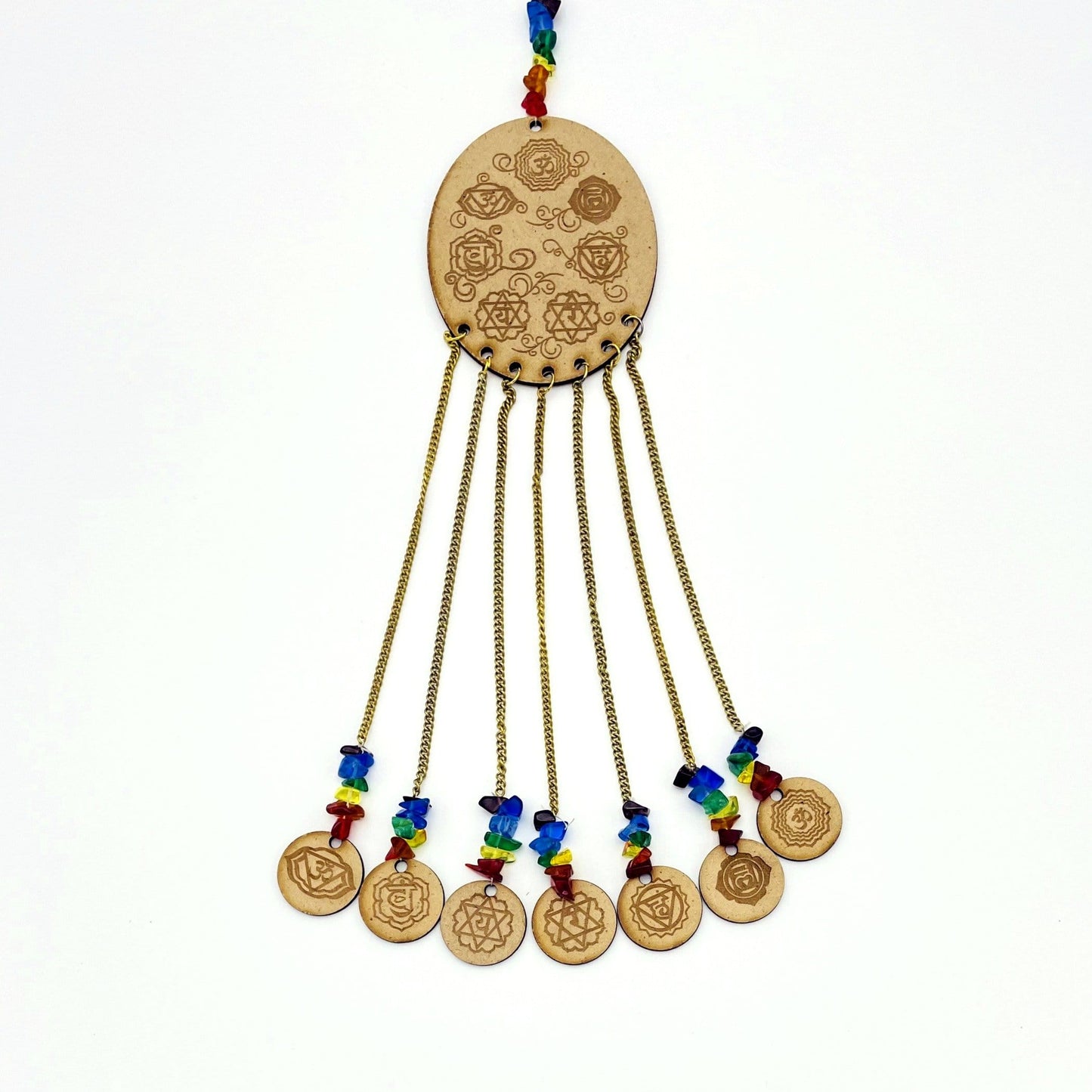 7 Chakra symbols on oval wooden piece with attached mini engraved wood circles on white background.