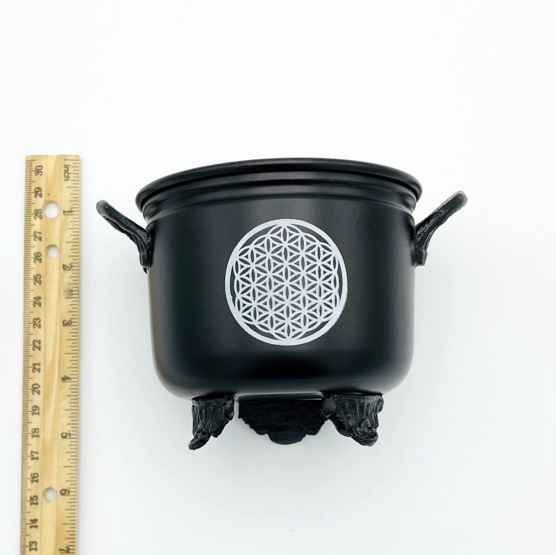 Metal Cauldron in black next to a ruler for size comparison 