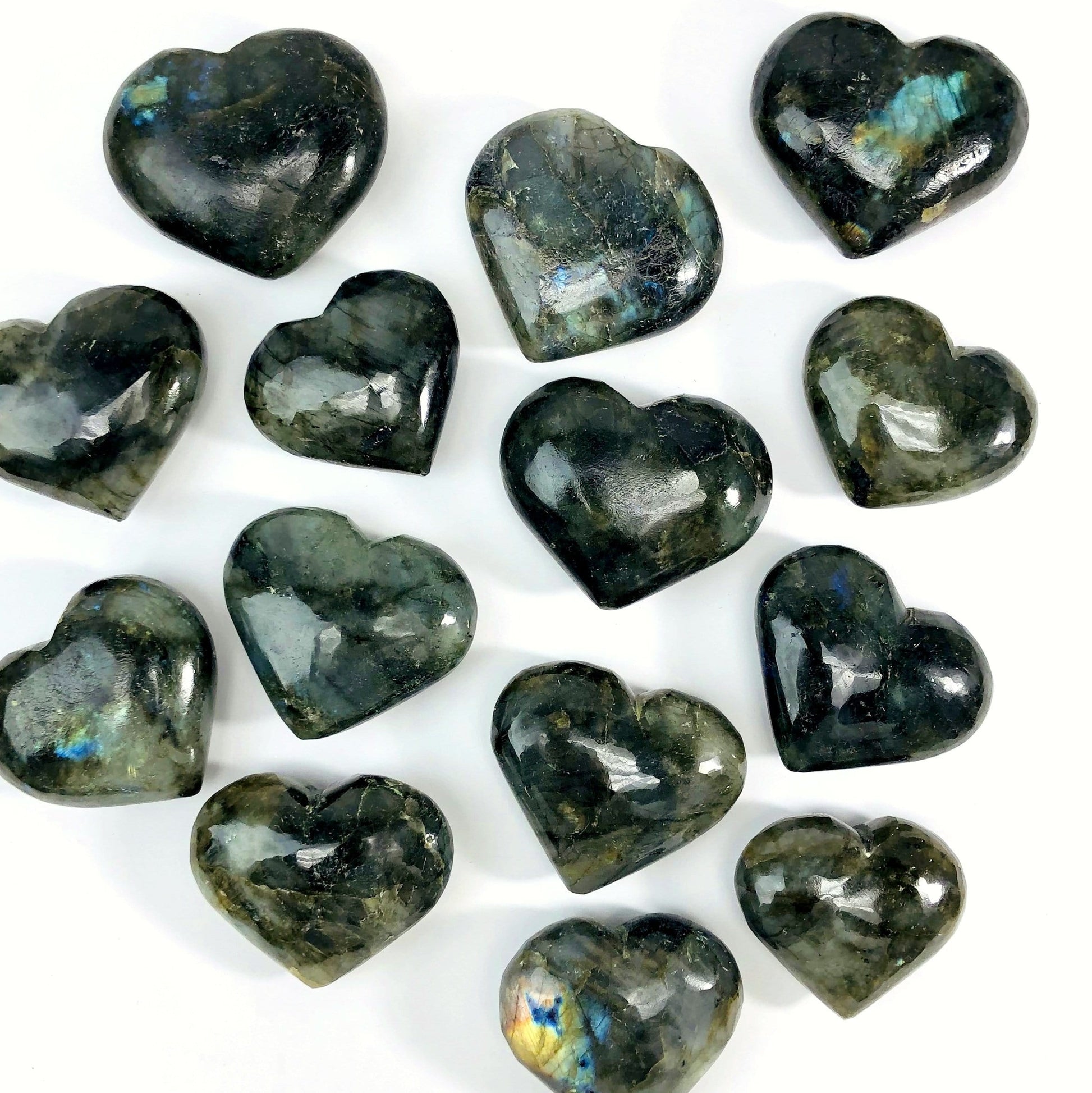 multiple labradorite hearts on white background displaying different sizes 