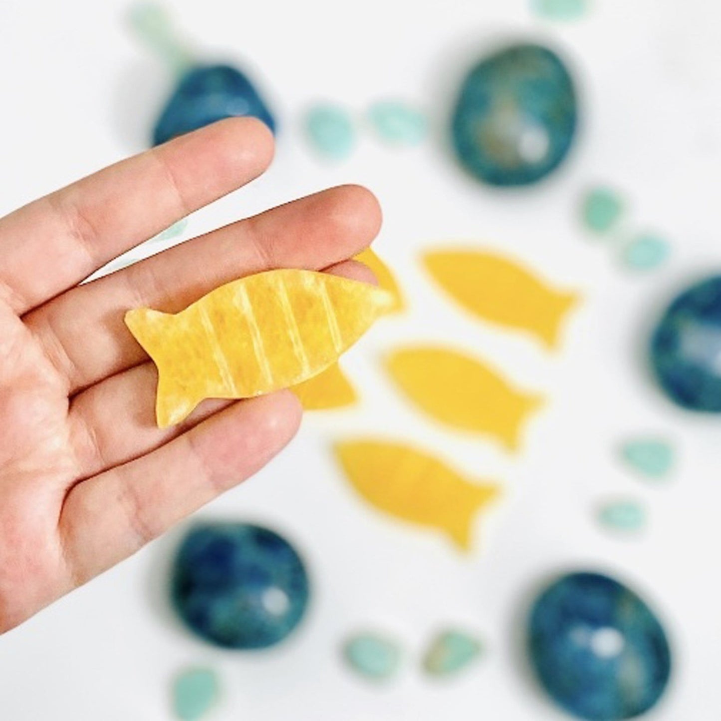 Orange Calcite Fish Slices - in a hand
