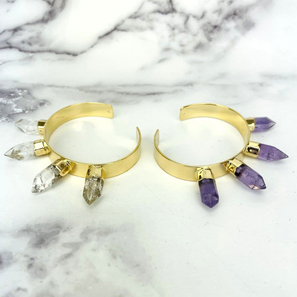 gold electroplated spike bracelet displayed in crystal quartz and amethyst on white background