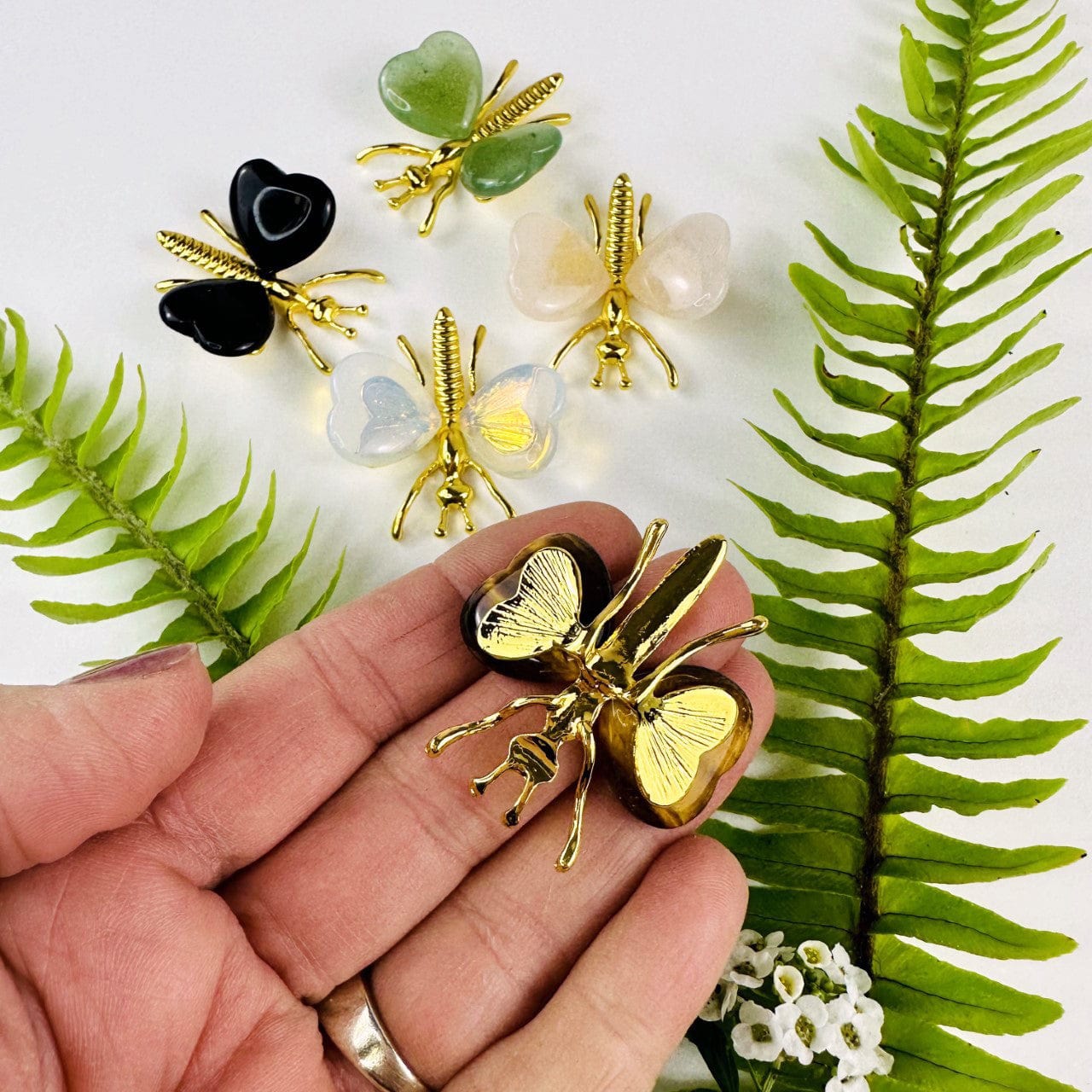 Gemstone Butterflies with Gold Tone Body  with 1 in a hand showing back side