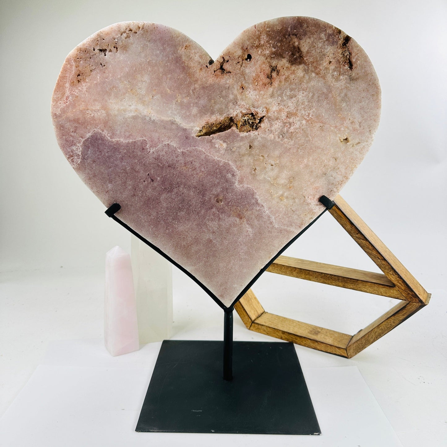 pink amethyst heart on stand with decorations in the background