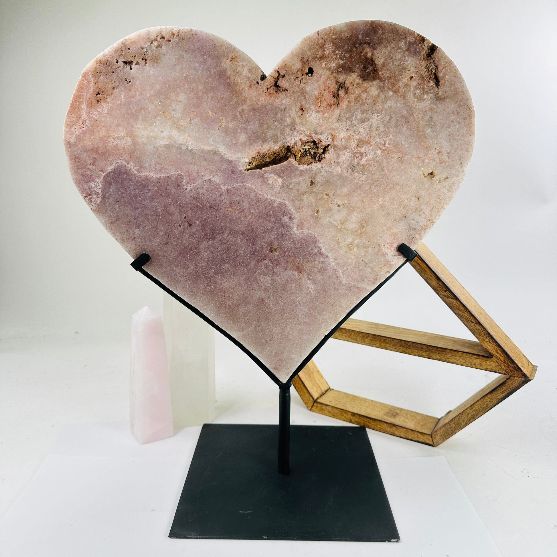 pink amethyst heart on stand with decorations in the background