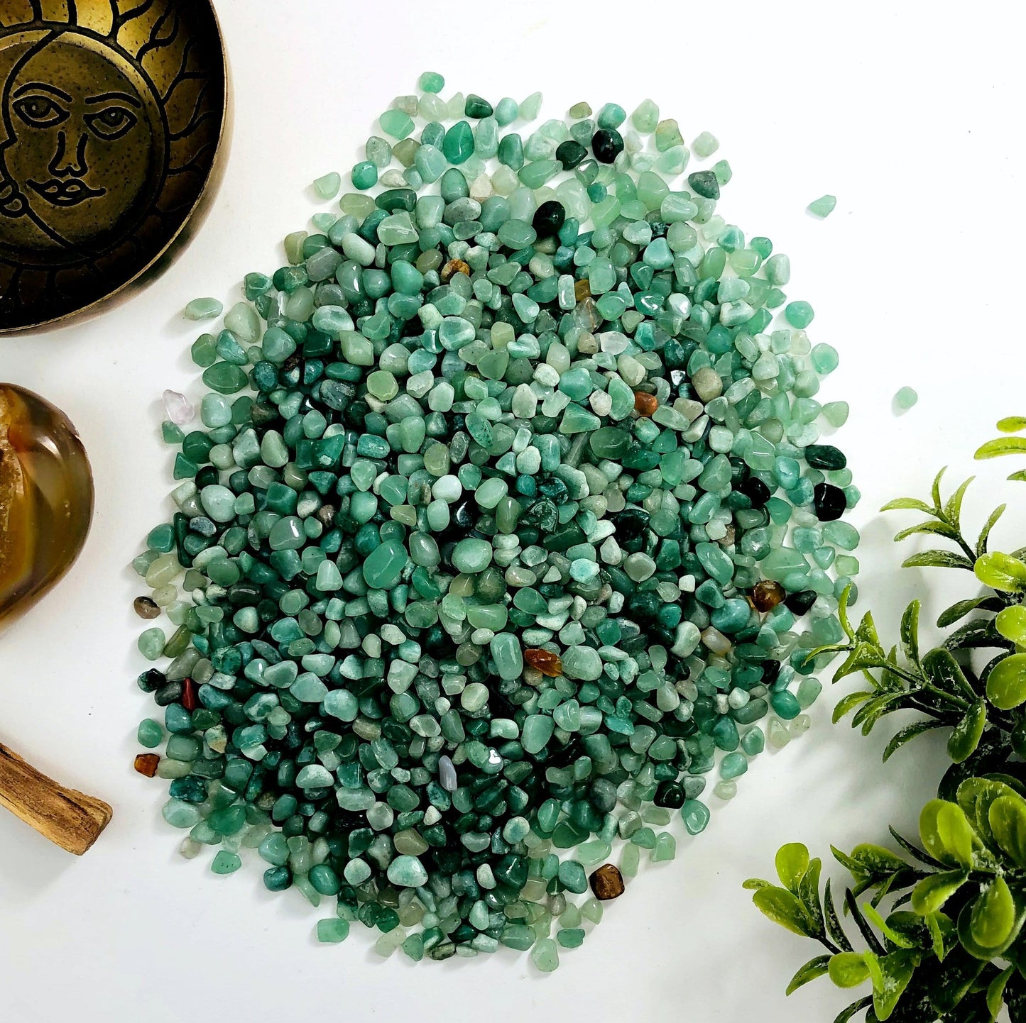 Green quartz chips on a white background.