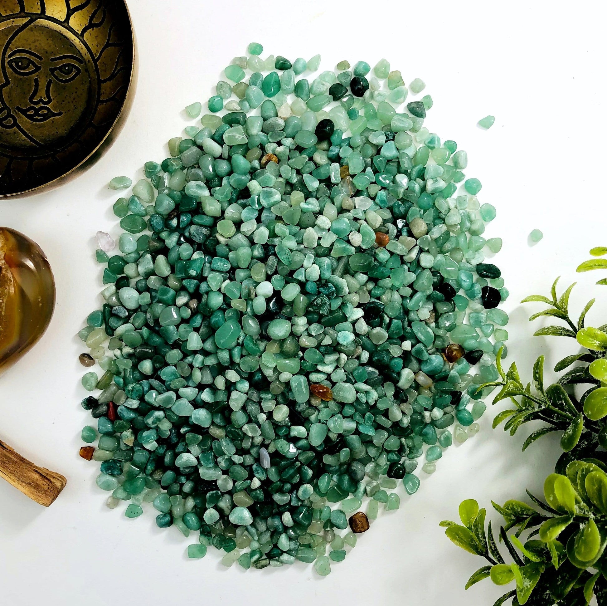 Green quartz chips on a white background.