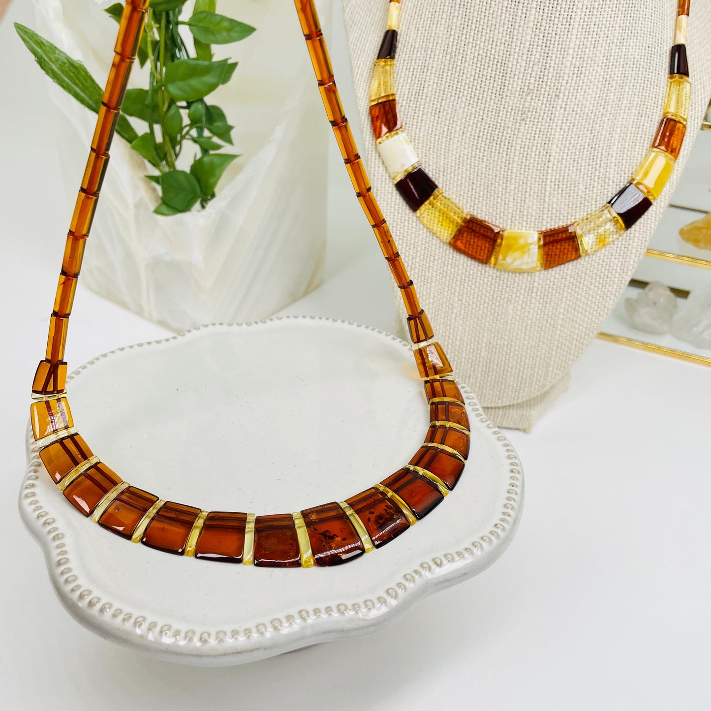 amber necklaces displayed to show the difference on the amber color shades 