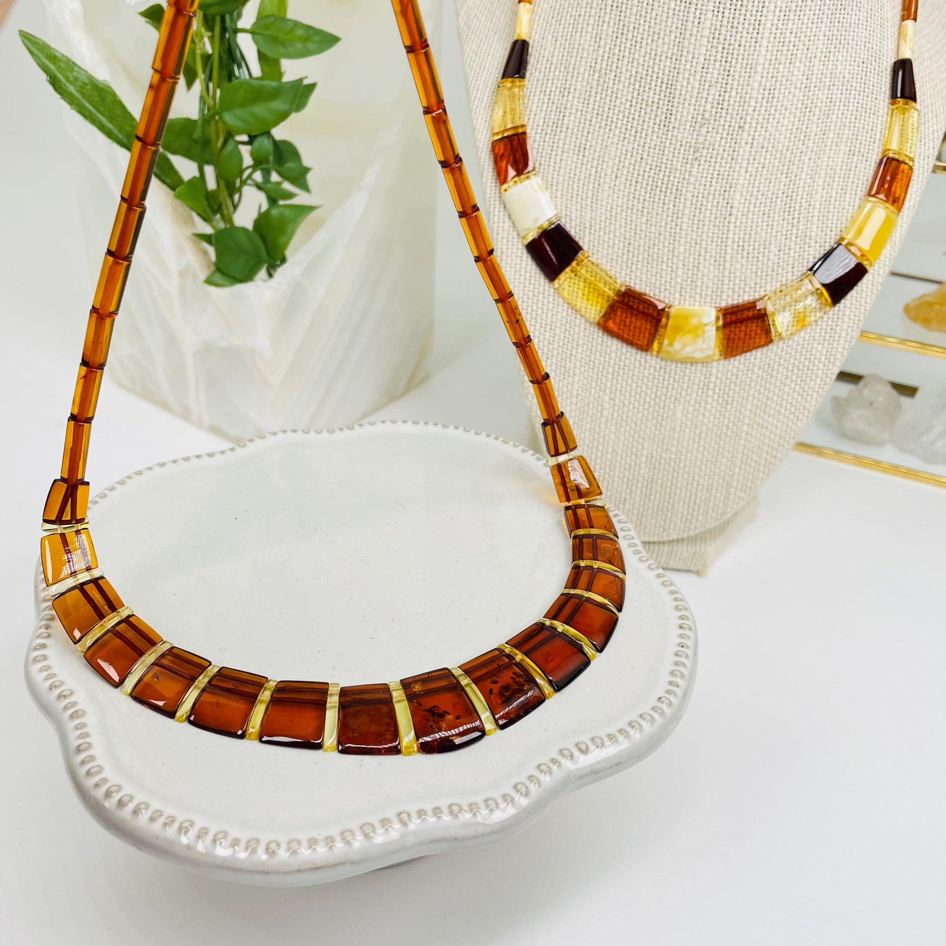 amber necklaces displayed to show the difference on the amber color shades 