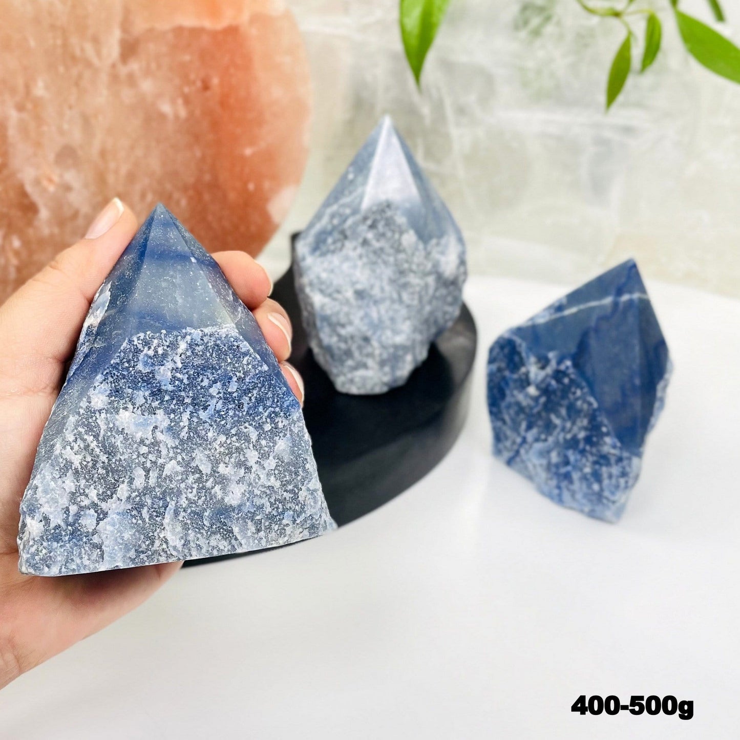 blue quartz point in hand for size reference 