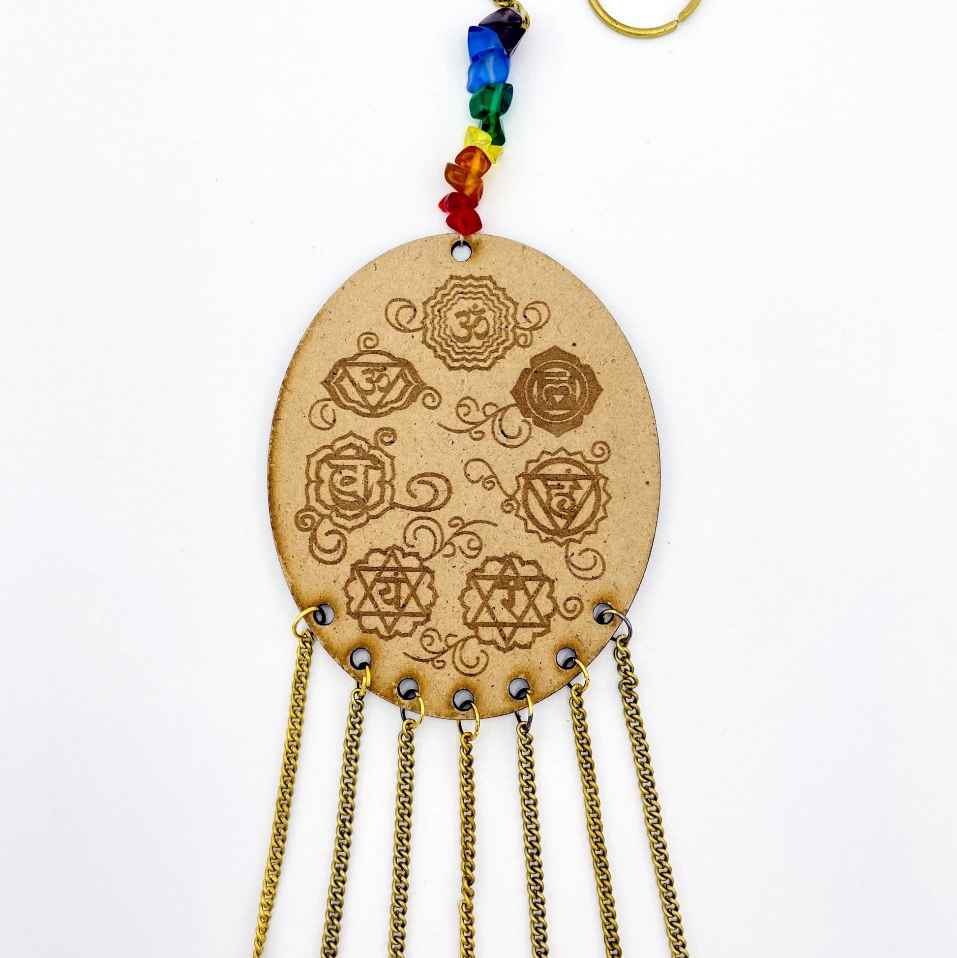 Beautiful Engraved 7 Chakra symbols on oval wooden piece.