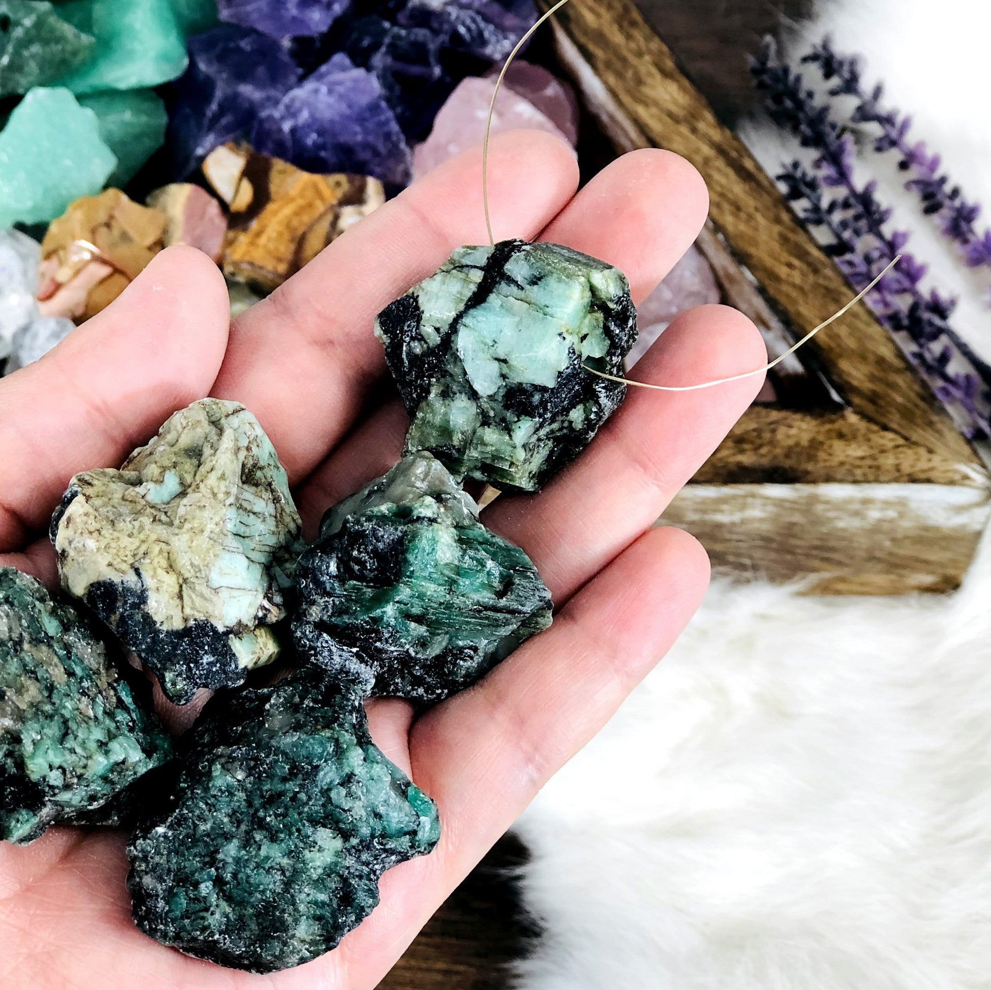 Rough Stone Beads with wire going through it with other beads in container blurred in the background