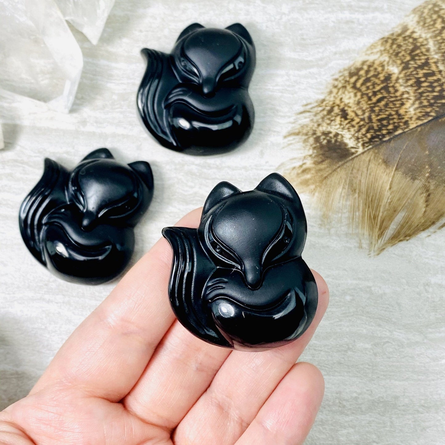 balck onyx fox bead in a hand