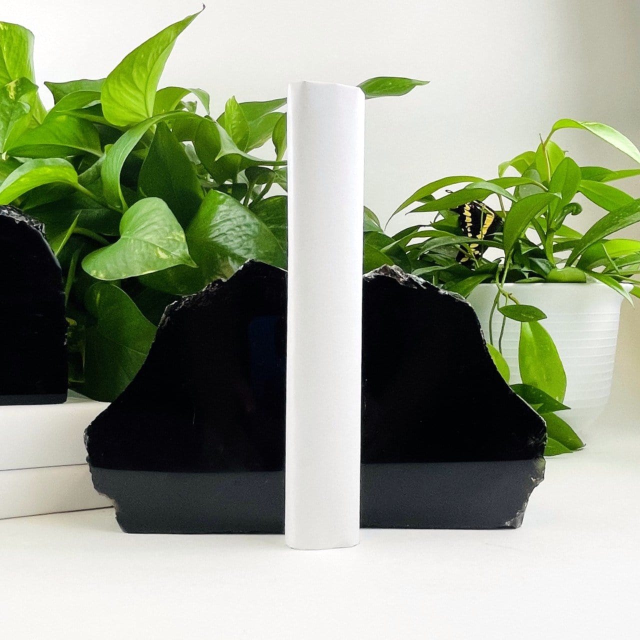 Polished Black Obsidian Bookend Set  displayed with a book 