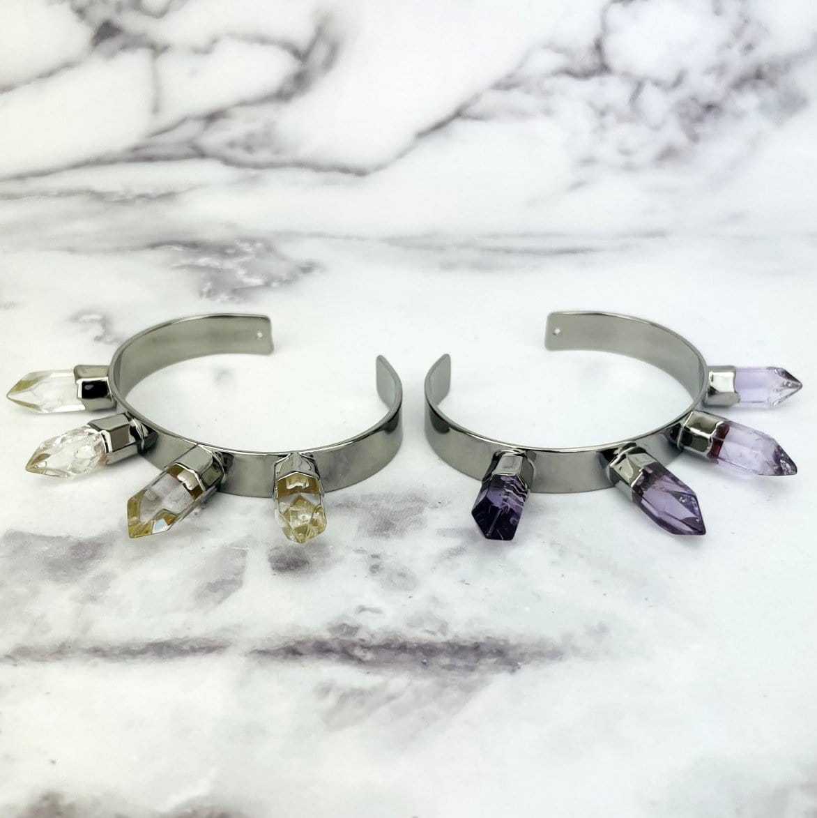 gunmetal electroplated spike bracelet displayed in crystal quartz and amethyst on white background