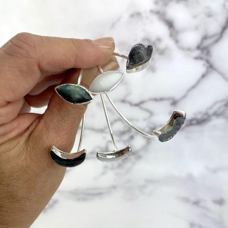 cuff bracelet with crescent moon on one end and marquise shape on the other end in silver