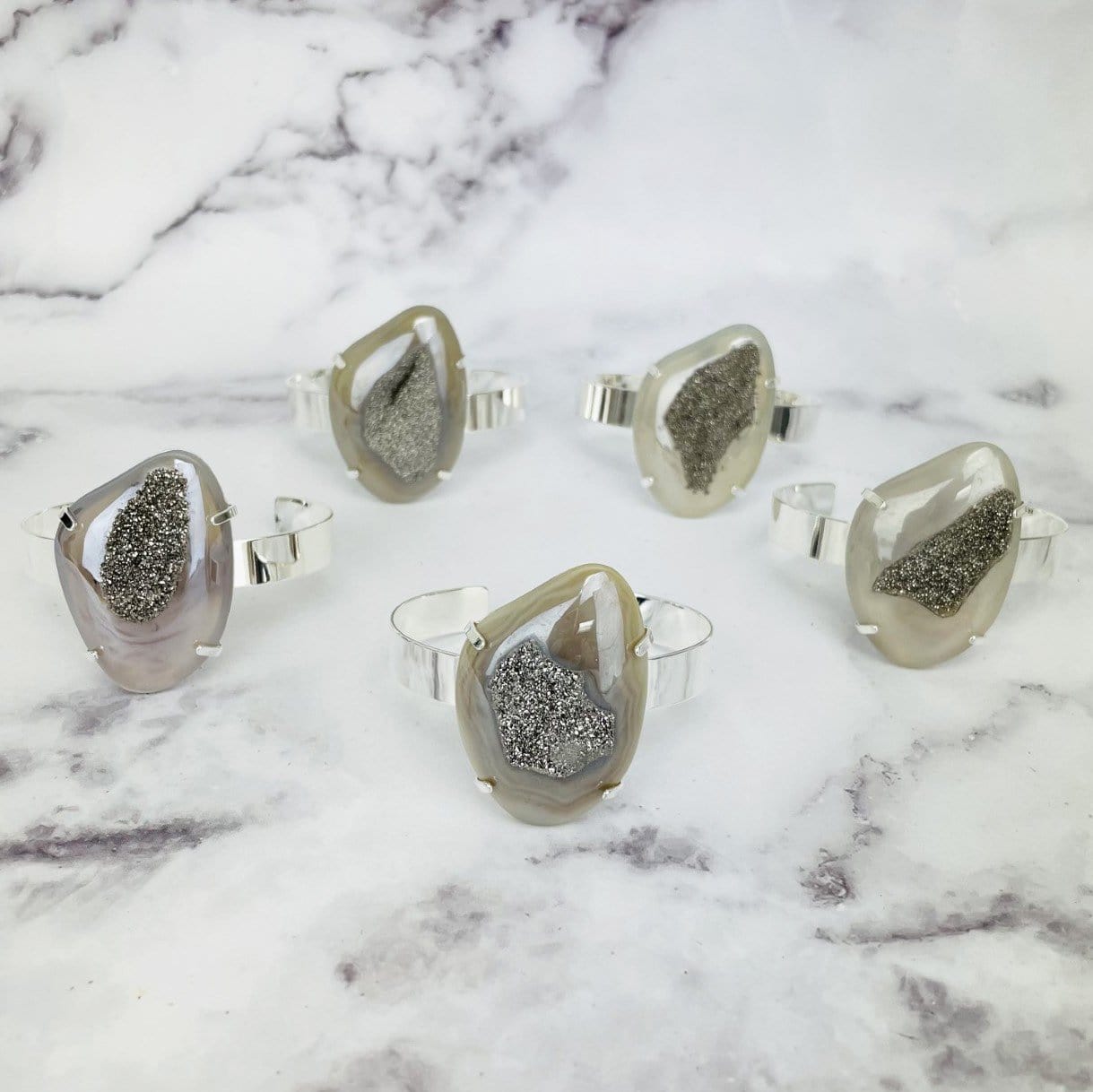 5 titanium druzy  angel aura agate bracelets on marble background