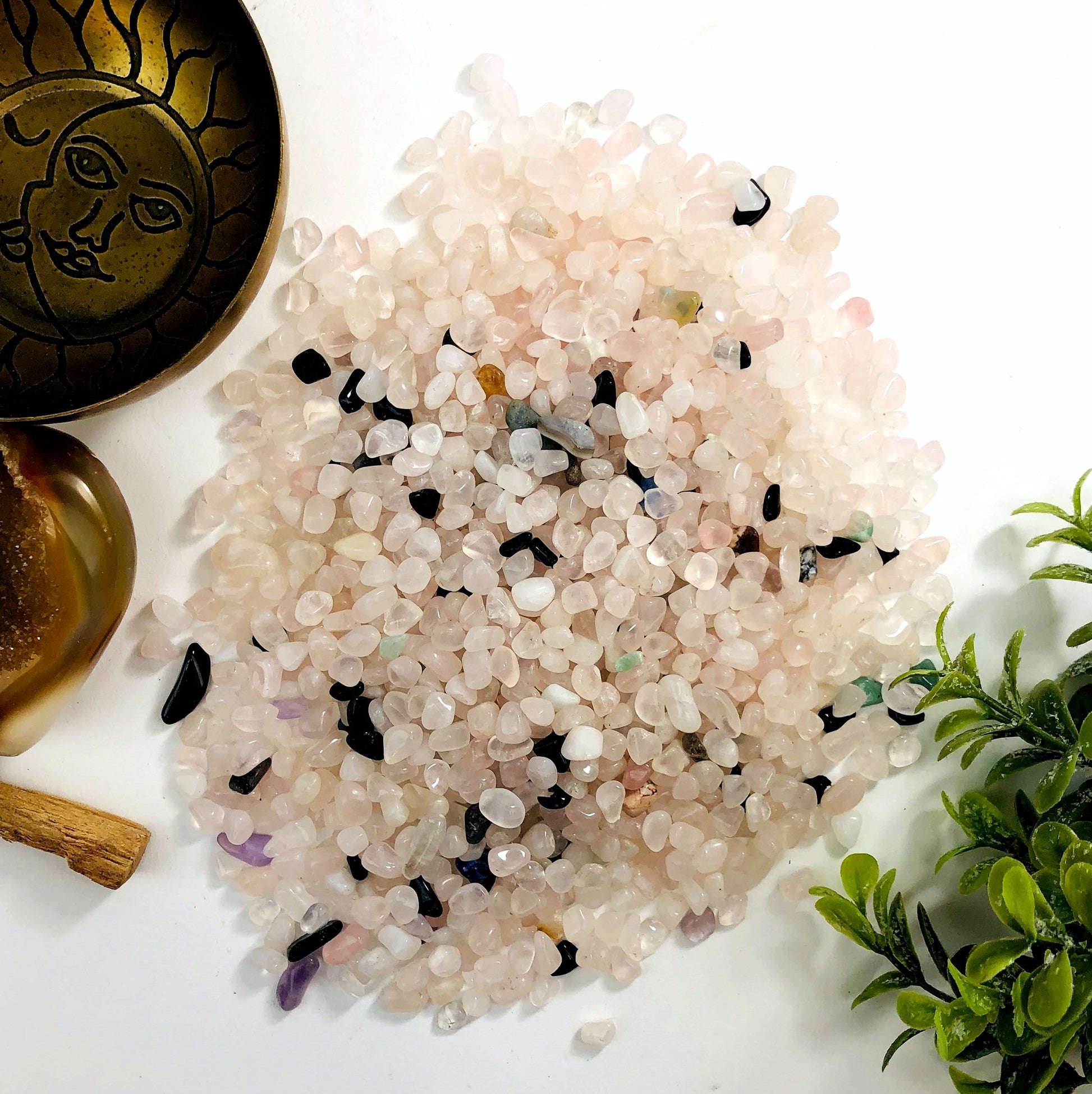 Rose quartz chips on a white background.