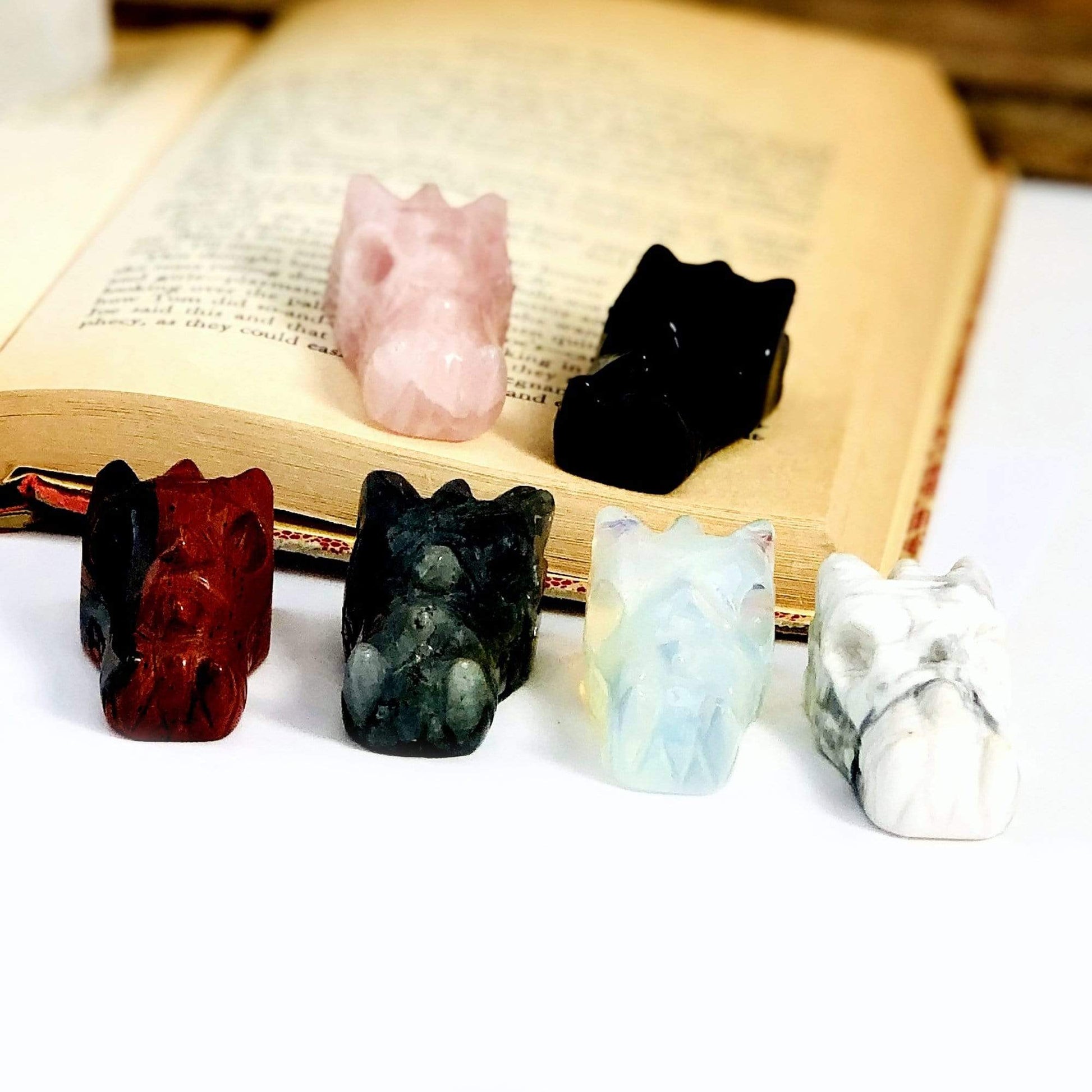 6 Different Dragon Head Mini Statues on White Background.