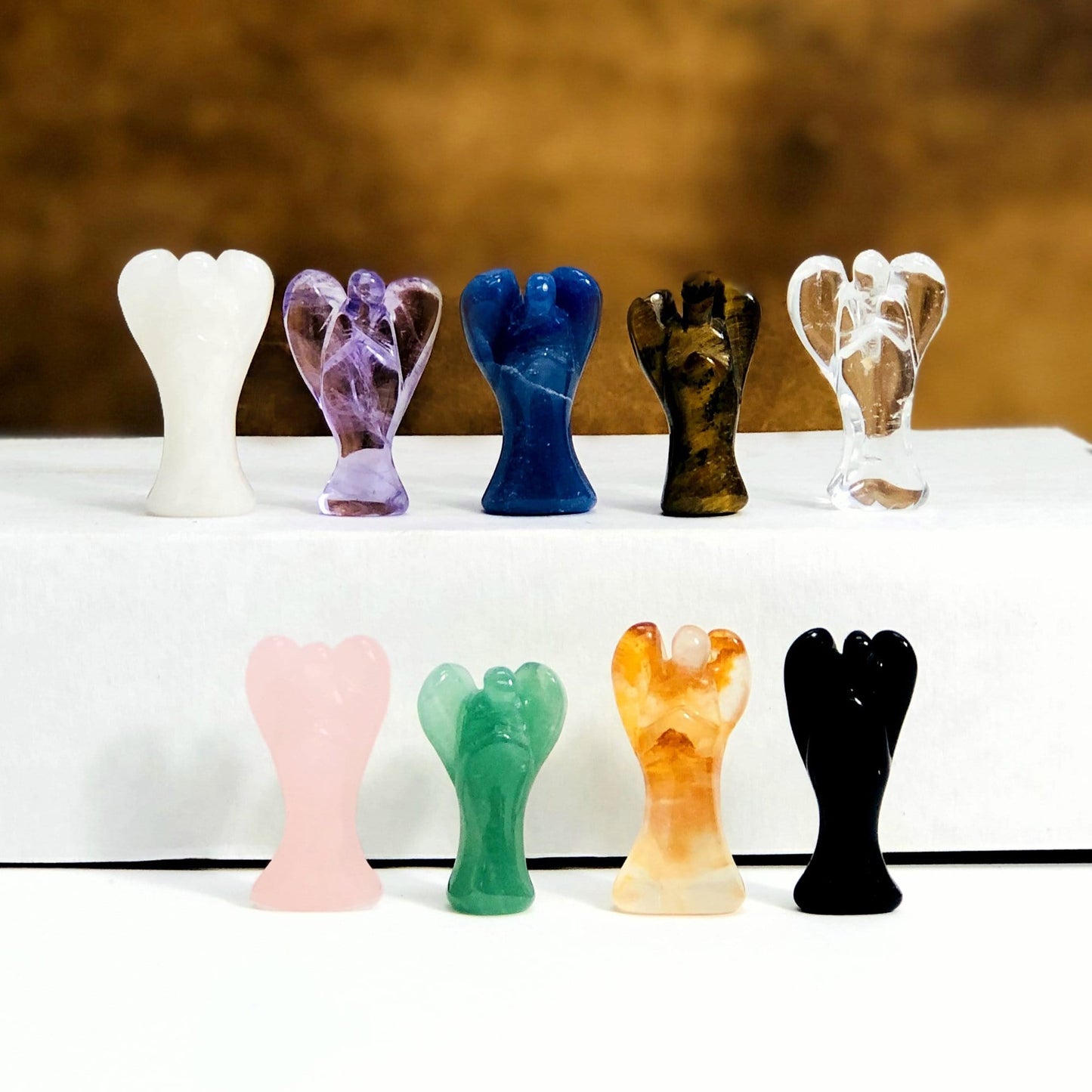 Gemstone Angel Cabochon  displayed to show they come in quartz amethyst blue quartz tigers eye clear quartz rose quartz green quartz golden healer obsidian
