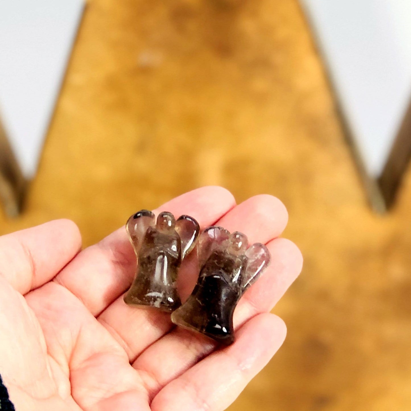 Smokey quartz angel in hand for size reference