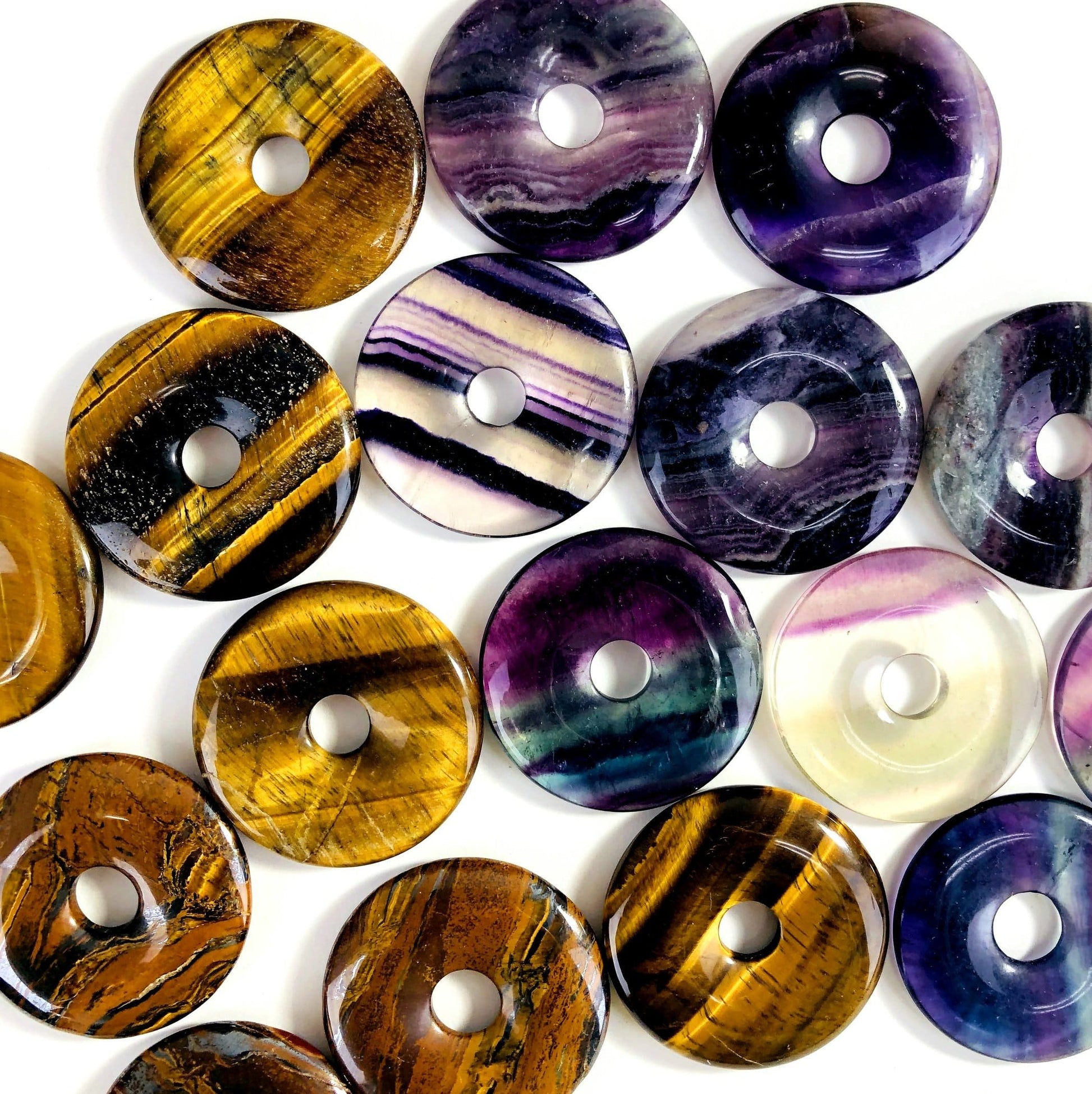 donut shaped polished stones on white background