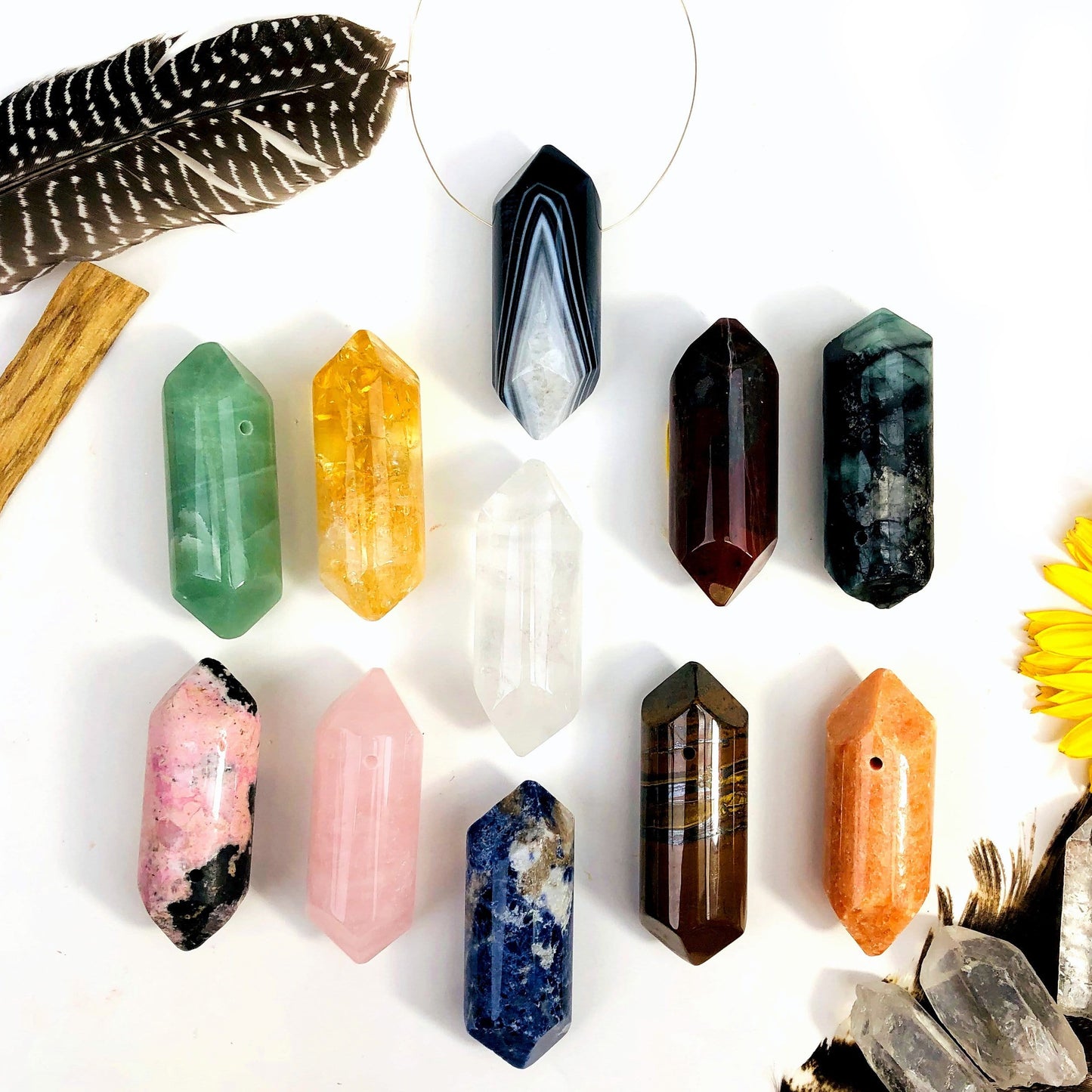 Gemstone Polished Drilled Points displayed to show they come in Green Aventurine Sun Stone Rhodonite Jasper Tigers Eye Emerald Sodalite Citrine Crystal Quartz Rose Quartz Black Agate