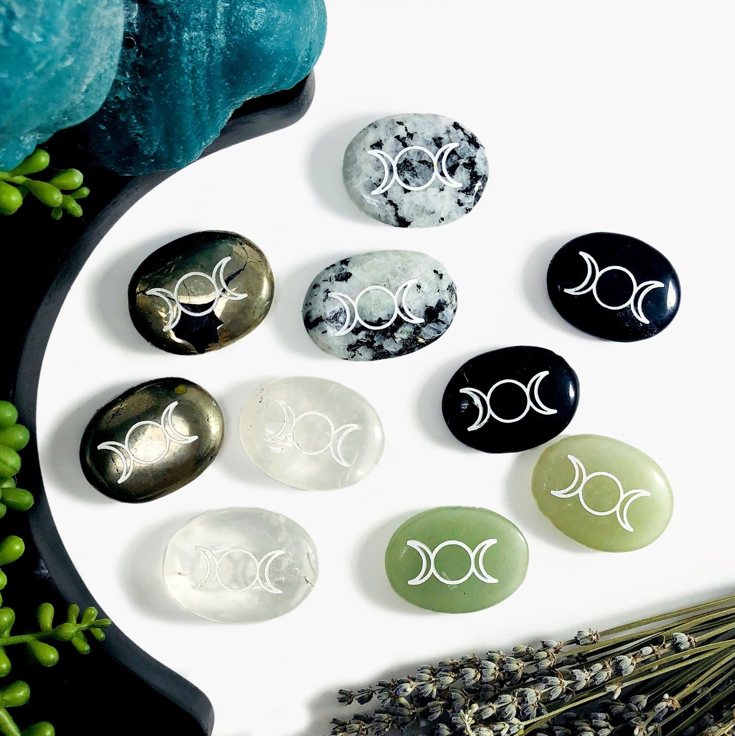 Variety front facing Palm Stones Pocket Stones with Moon Phase in an alter to display variations with a white background.