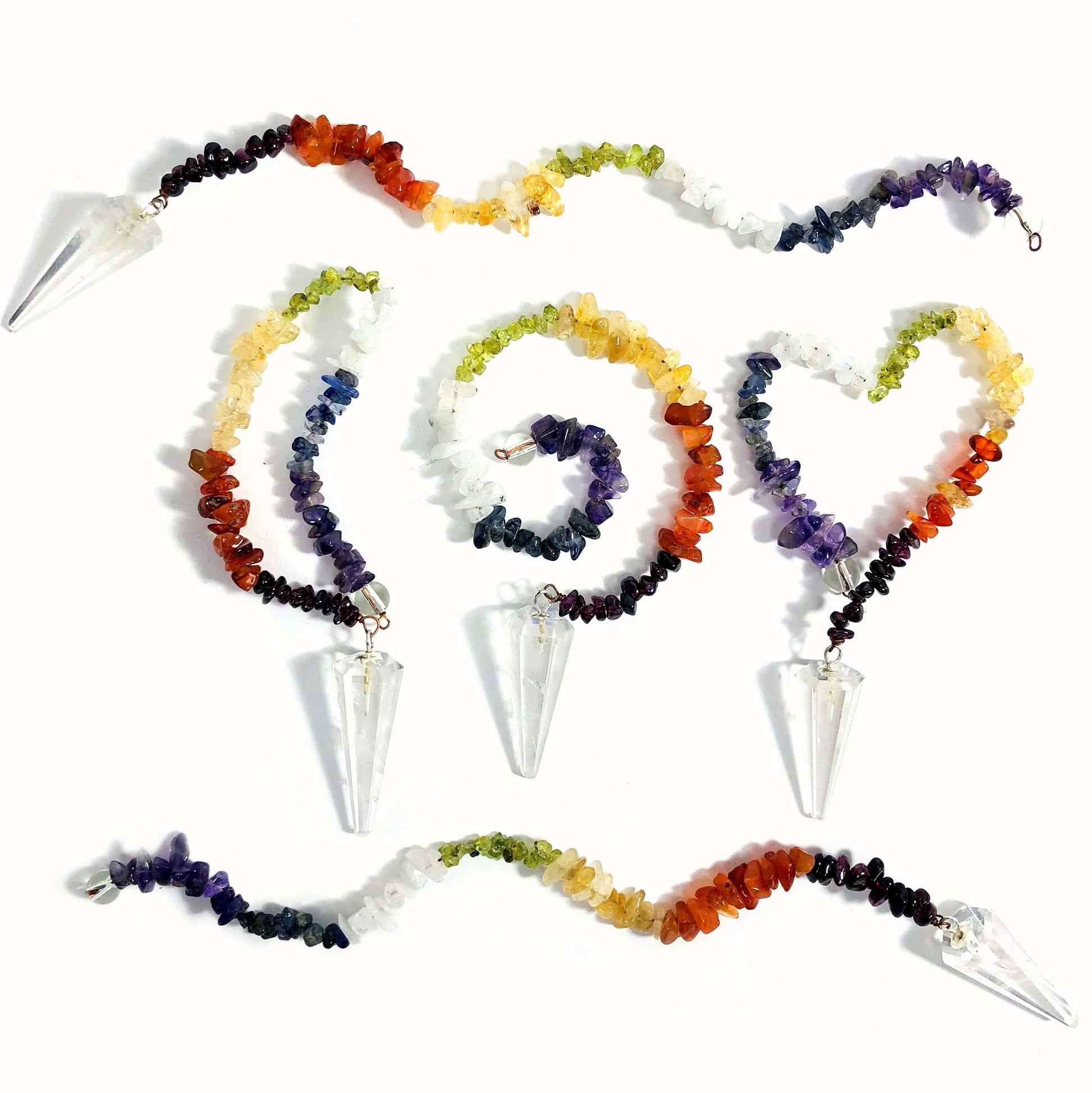 Crystal Quartz Pendulum with Chakra Beads  - 5 on a table