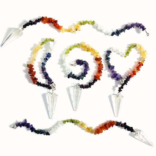 Crystal Quartz Pendulum with Chakra Beads  - 5 on a table