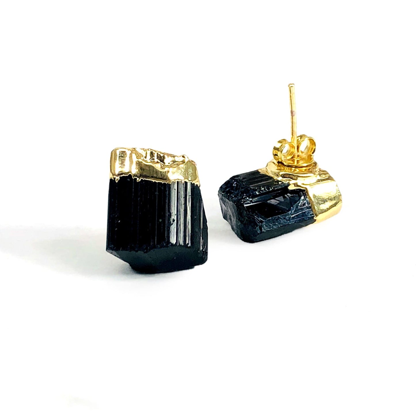 Black tourmaline small stud earrings with gold plated top on a white background.