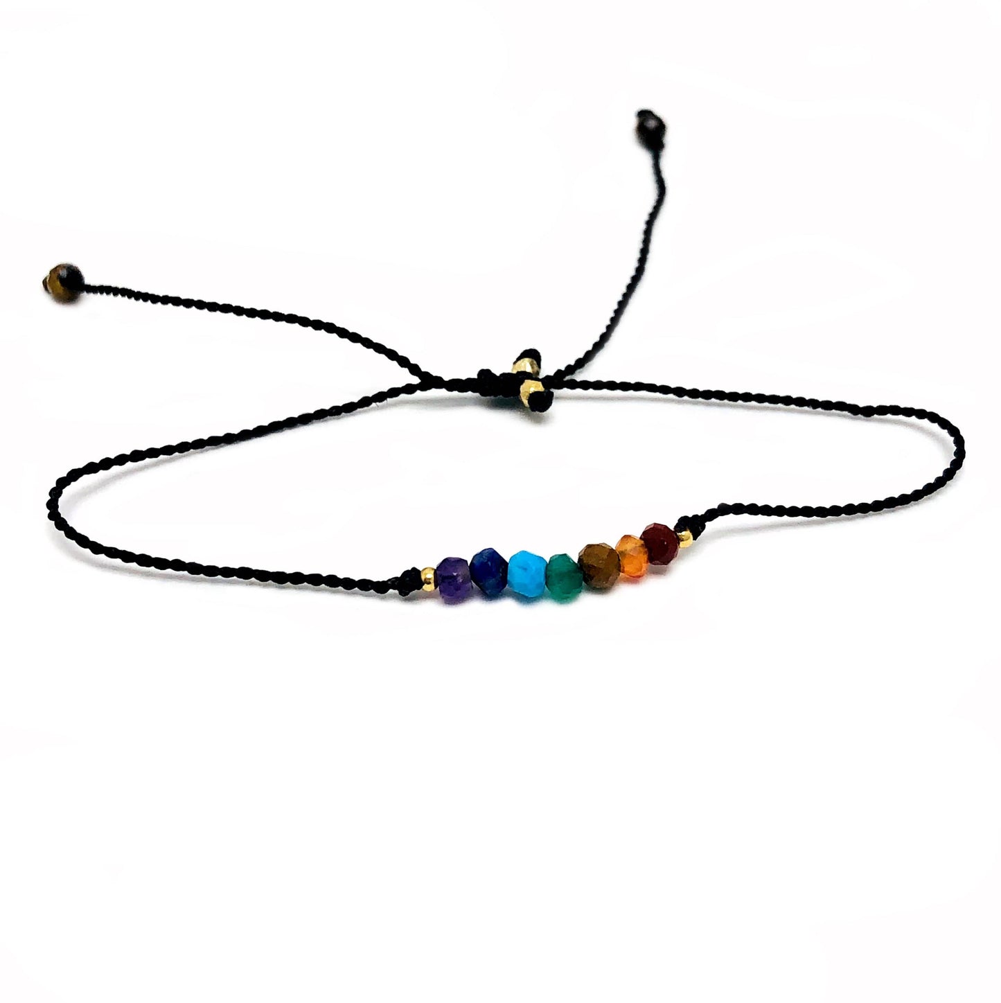 close up of the details on these chakra themed mini bead bracelets 