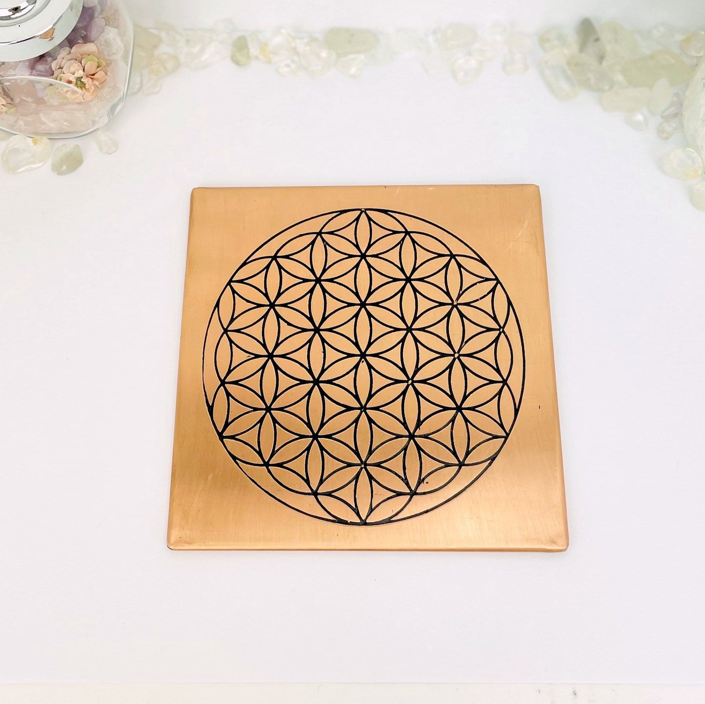 copper square flat plate with a flower of life grid in black on it