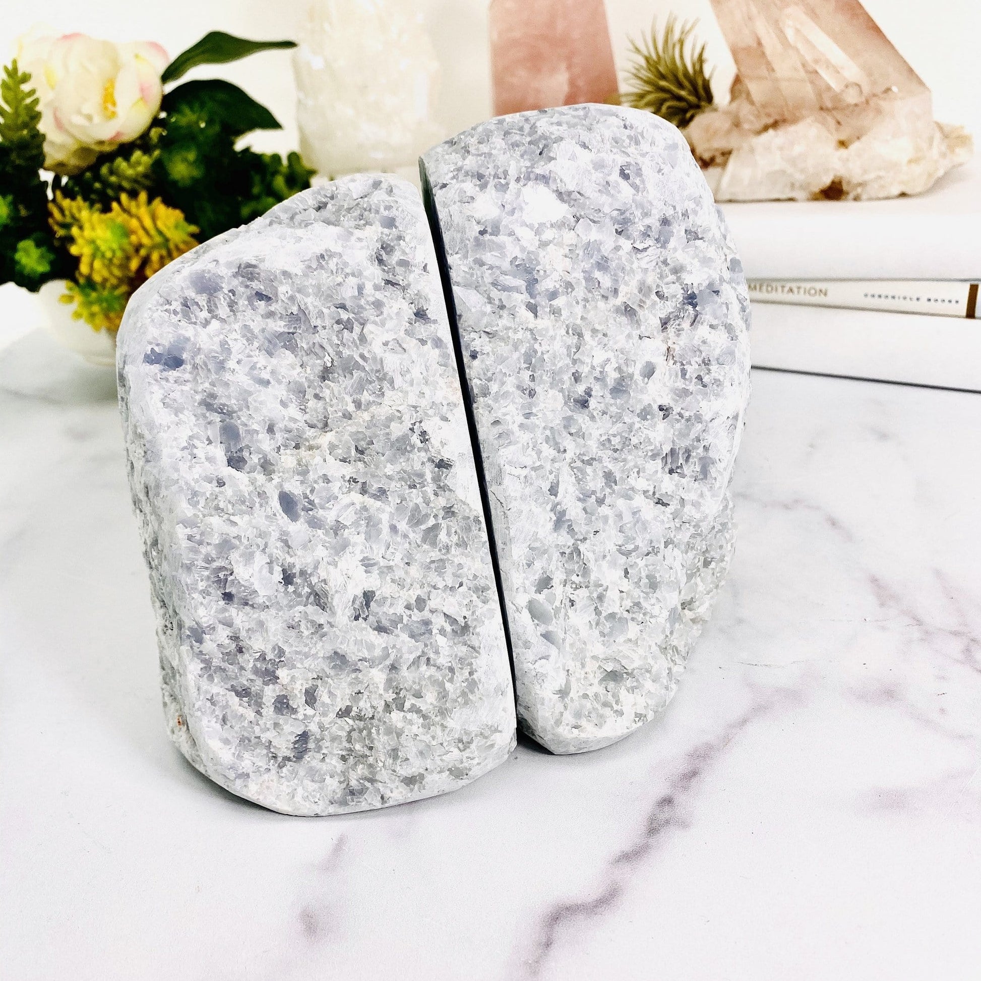 up close shot of blue calcite bookend with decorations in the background