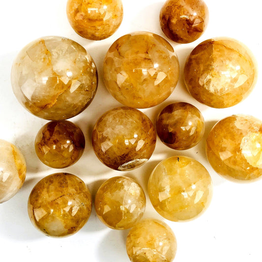 golden healer polished spheres on white background