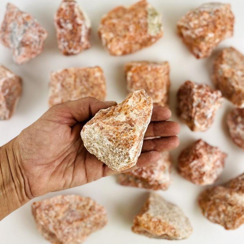 orchid calcite stone in hand 